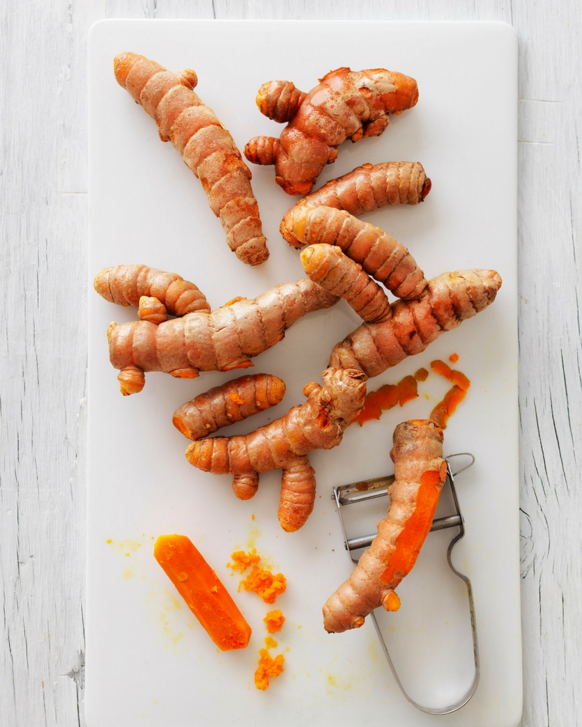 Fresh Turmeric Root Benefits Fresh turmeric roots with a grater